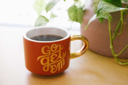 Mug on the desk of side hustle manager during lockdown