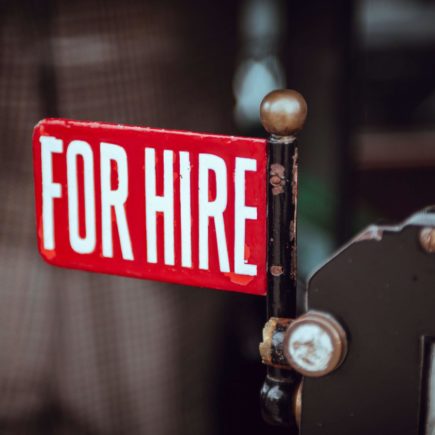 For hire sign displayed by a job hunter