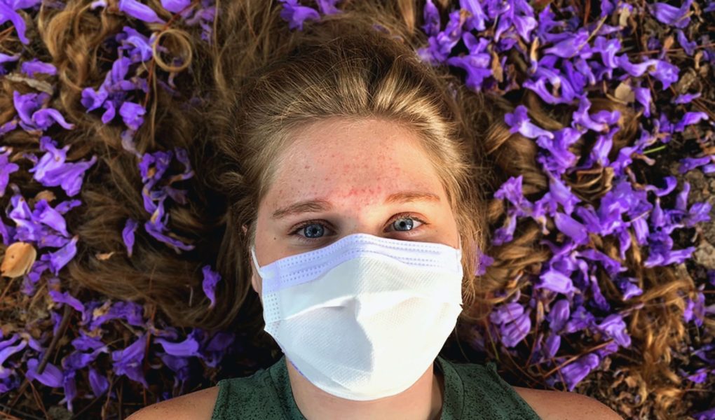 Person in mask struggling with COVID anxiety