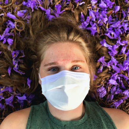 Person in mask struggling with COVID anxiety
